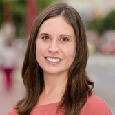 brunette woman in pink shirt