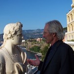 man pretending to talk to statue